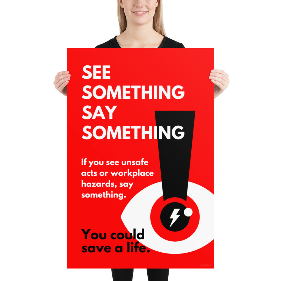 A workplace safety poster with a bright red background an an eye with an exclamation point coming from the pupil and a lightning bolt in the middle of the pupil with text that says "See Something Say Something" in bold lettering with the words "If you see unsafe acts or workplace hazards, say something. You could save a life."