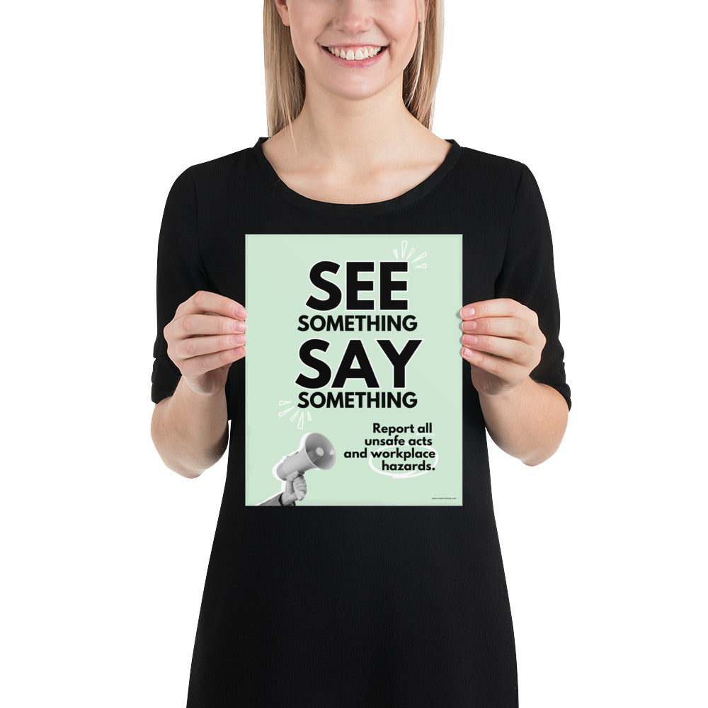 A workplace safety poster with a mint green background, and a greyscale hand holding a megaphone with large text saying "See Something, Say Something" and small text underneath it that says "Report all unsafe acts and workplace hazards" with white doodles to emphasize the text.