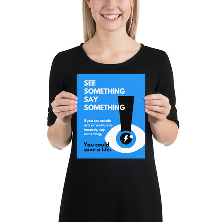 A workplace safety poster with a bright blue background an an eye with an exclamation point coming from the pupil and a lightning bolt in the middle of the pupil with text that says "See Something Say Something" in bold lettering with the words "If you see unsafe acts or workplace hazards, say something. You could save a life."