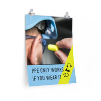 An PPE safety poster showing an extreme close up of a man wearing a blue hard hat and safety glasses plugging his ear with an ear plug with a safety slogan and infographics of hearing PPE below him.