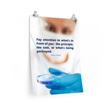 Safety poster showing a close up of a woman's face wearing safety glasses and a white face mask, holding a petri dish and pipette with a safety quote written in blue text.