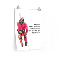 A safety poster showing a worker performing a controlled descent while wearing a fall protection harness on a bright white background with a quote from Archilochus to the right.