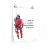 A safety poster showing a worker performing a controlled descent while wearing a fall protection harness on a bright white background with a quote from Archilochus to the right.