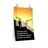 A construction safety poster showing the silhouette of a construction worker working on a building with a bright yellow sunset in the background and a safety slogan in the bottom left corner.