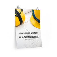 A safety poster showing a yellow hard hat and yellow ear muffs on blueprints with a safety quote by Johann Wolfgang von Goethe that says "Knowing is not enough, we must apply. Willing is not enough, we must do."