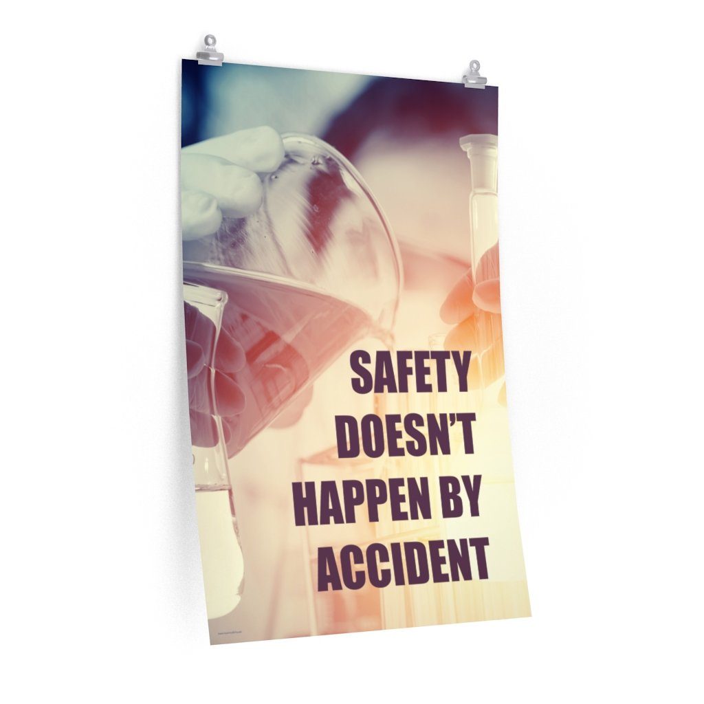 Safety poster showing a close up of 3 hands wearing gloves holding glass beakers and a safety slogan that says "Safety doesn't happen by accident" written in bottom right corner.