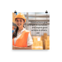 Safety poster showing a female warehouse worker smiling and wearing an orange reflective safety vest and orange hard hat with a safety quote written in dark text.
