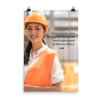 Safety poster showing a female warehouse worker smiling and wearing an orange reflective safety vest and orange hard hat with a safety quote written in dark text.
