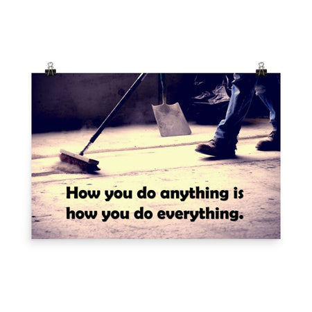 Safety poster showing a closeup of the ground where a warehouse or construction worker is sweeping the workshop floor and an encouraging safety slogan written in bold text.