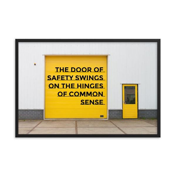 Workplace safety poster depicting a bright yellow garage door to a warehouse with a bold safety slogan on it with a smaller yellow door to the right.