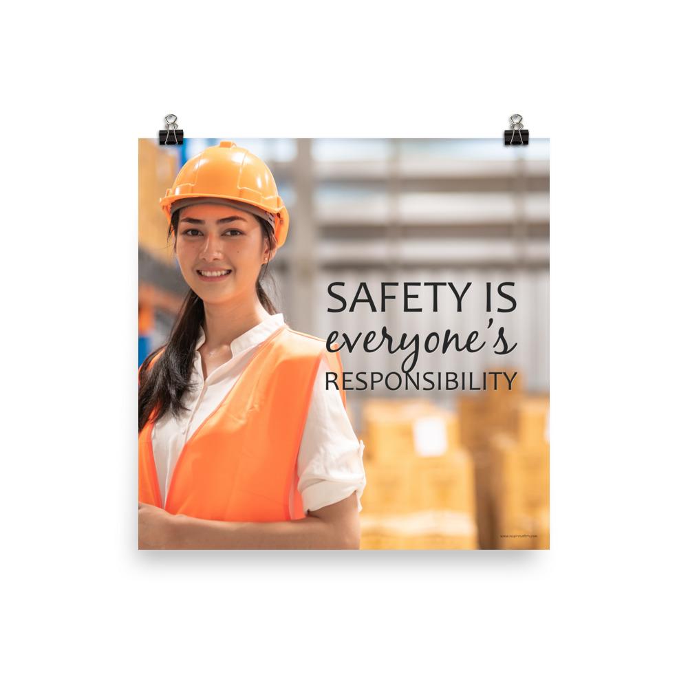 A workplace safety poster showing a young warehouse worker in a yellow hardhat and orange reflective vest holding a clipboard and smiling with the slogan safety is everyone's responsibility.