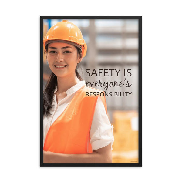 A workplace safety poster showing a young warehouse worker in a yellow hardhat and orange reflective vest holding a clipboard and smiling with the slogan safety is everyone's responsibility.
