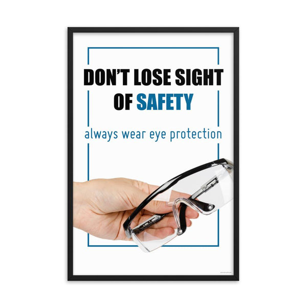 An eye safety slogan showing a close up of a hand presenting out safety glasses with a safety slogan in blue text above.