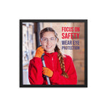 An eye safety poster of a young woman wearing safety glasses and orange gloves smiling as she works in a warehouse with a safety slogan in the top right corner.
