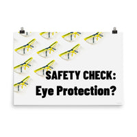 An eye safety poster depicting many clear safety glasses with yellow trim neatly lined up in rows and rows with a safety slogan in the foreground.