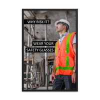 A safety poster showing a construction worker in a reflective orange vest, hard hat, and safety glasses on a construction site looking out with a safety slogan to the left.