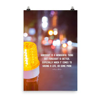 A workplace safety poster depicting a bright orange construction traffic light in the foreground of a blurry nighttime cityscape with a safety quote by William Blake.