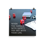 A workplace safety poster of a glossy black table with red dice, playing cards, and poker chips strewn everywhere with a safety slogan in the bottom left corner.