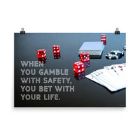 A workplace safety poster of a glossy black table with red dice, playing cards, and poker chips strewn everywhere with a safety slogan in the bottom left corner.