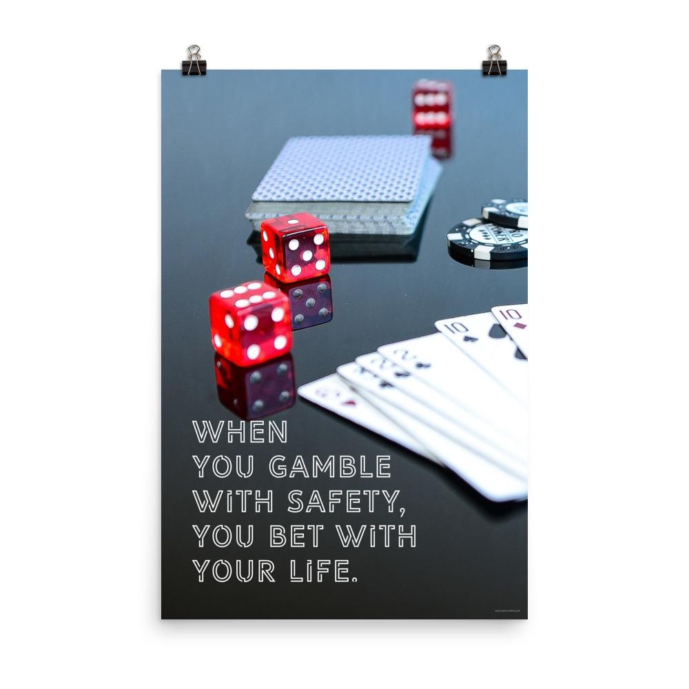 A workplace safety poster of a glossy black table with red dice, playing cards, and poker chips strewn everywhere with a safety slogan in the bottom left corner.