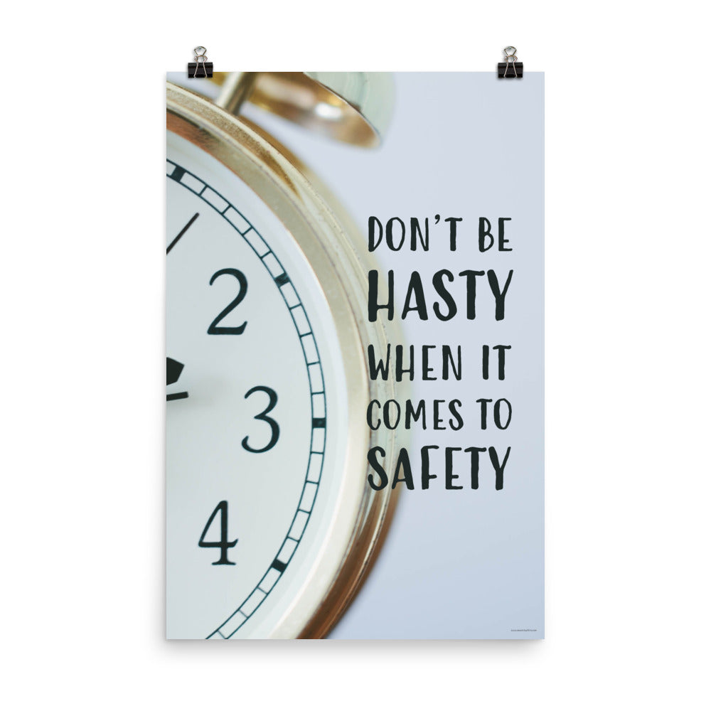 A workplace safety poster showing a close-up of a clock face with the slogan don't be hasty when it comes to safety.