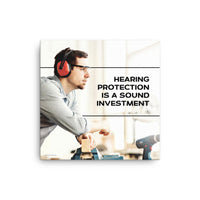 A workplace safety poster of a man in safety glasses and earmuffs taking a break in his woodshop with a safety slogan to the right.