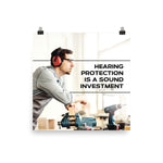 A workplace safety poster of a man in safety glasses and earmuffs taking a break in his woodshop with a safety slogan to the right.