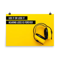 A hearing protection safety poster depicting bright yellow ear muffs on a bright yellow background in the bottom right corner with a bold safety slogan in the upper left corner.
