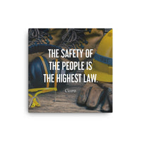 A safety poster showing a close-up of various PPE including safety glasses, ear muffs, gloves, a hard hat, and work boots with the quote by Cicero in the foreground.