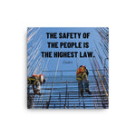A safety poster showing construction workers scaling rebar with a bright blue sky as the background and a safety quote in black block text.