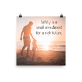 A workplace safety poster showing a father and his young daughter walking on the shore of a beach with a beautiful sunset in the background and text saying safety is a small investment for a rich future.