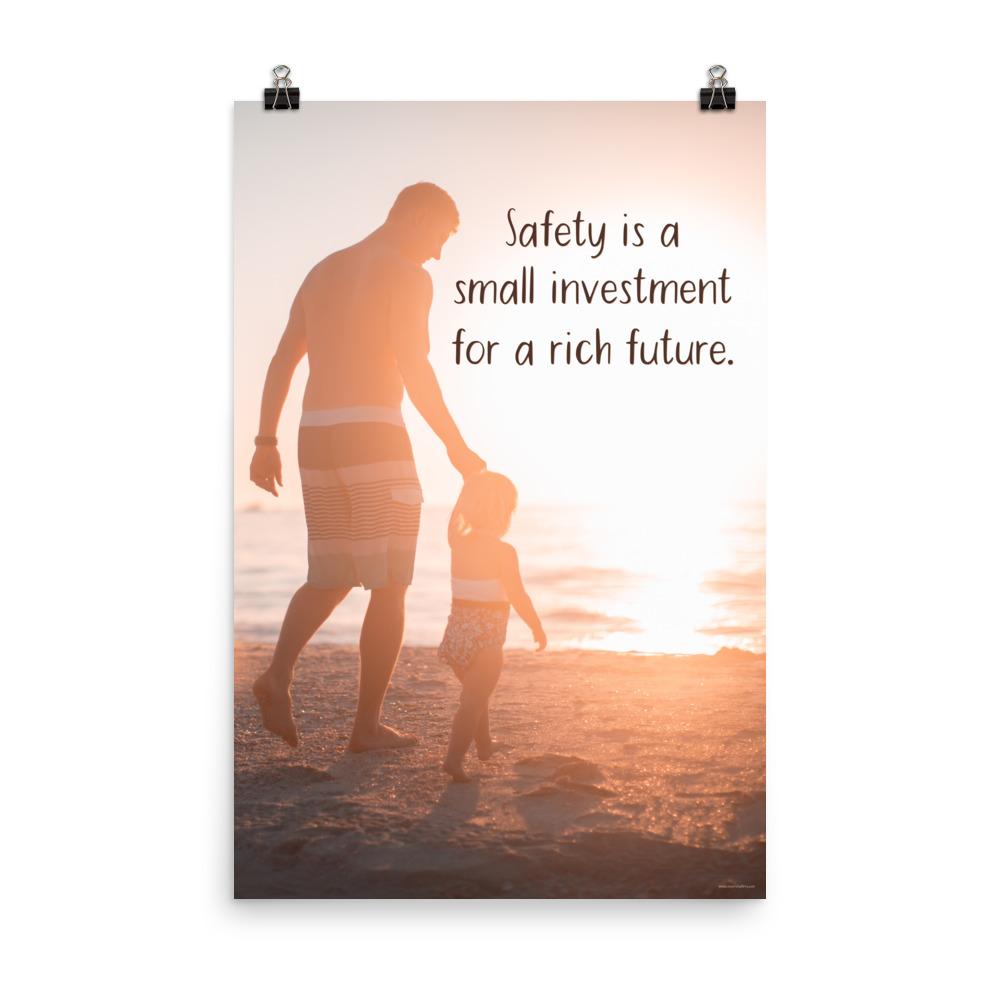 A workplace safety poster showing a father and his young daughter walking on the shore of a beach with a beautiful sunset in the background and text saying safety is a small investment for a rich future.