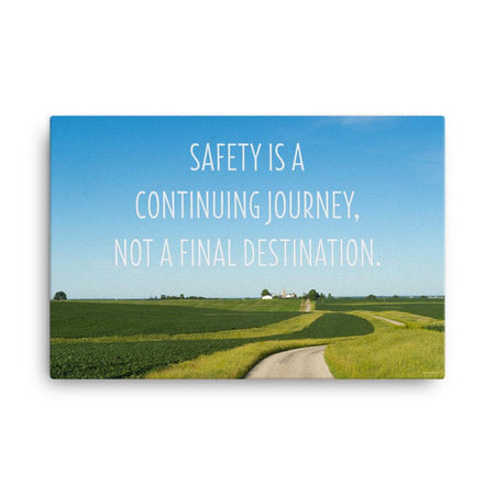 A workplace safety poster depicting a beautiful sunny day with a bright blue sky and a lush green field being cut down the middle by a dirt road leading off into the countryside with the text safety is a continuing journey, not a final destination.