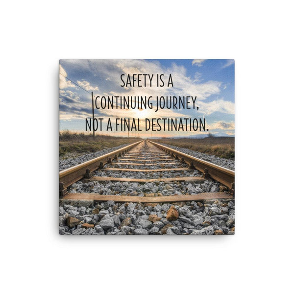 A workplace safety poster depicting old railroad tracks leading into a cloudy horizon with the text safety is a continuing journey, not a final destination.