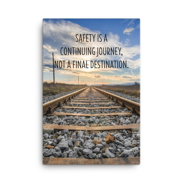 A workplace safety poster depicting old railroad tracks leading into a cloudy horizon with the text safety is a continuing journey, not a final destination.