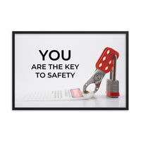 A workplace safety poster showing a lockout tagout lock and tag with the text you are the key to safety.