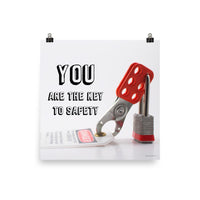 A workplace safety poster showing a lockout tagout lock and tag with the text you are the key to safety.