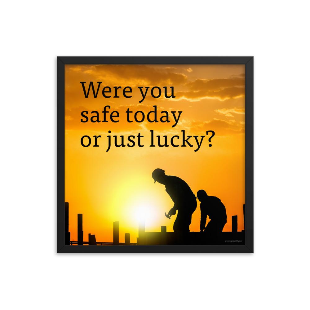A workplace safety poster showing workers on a construction site being silhouetted in black with a sunset of orange hues in the background with the slogan were you safe today, or just lucky?