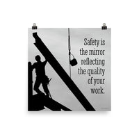 A workplace safety poster showing a construction ironworker working on a construction site with everything silhouetted black with a light grey background and with the slogan safety is the mirror reflecting the quality of your work.