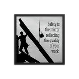 A workplace safety poster showing a construction ironworker working on a construction site with everything silhouetted black with a light grey background and with the slogan safety is the mirror reflecting the quality of your work.