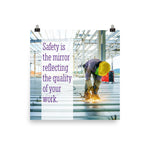 A workplace safety poster showing a construction worker wearing all of the proper PPE and bending over to work on a huge sheet of metal with sparks flying everywhere with the slogan safety is the mirror reflecting the quality of your work.