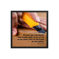 A workplace safety poster showing a close-up of hands opening a box using a boxcutter with a safety quote below the hands.