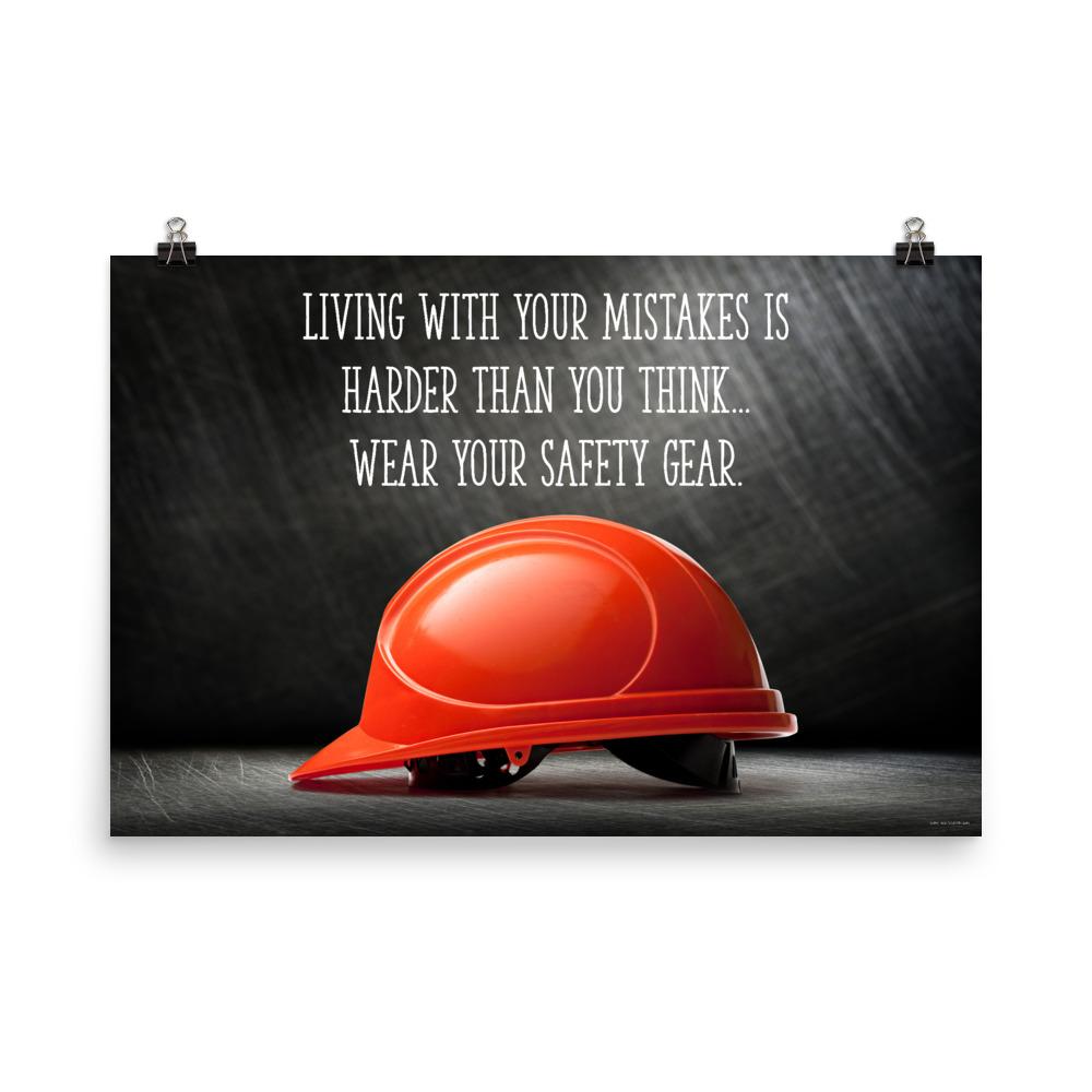 A workplace safety poster showing a bright red hard hat with an ominous black background with the slogan living with your mistakes is harder than you think, wear your safety gear.