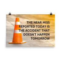 A workplace safety poster showing an orange safety cone with the slogan the near miss reported today is the accident that doesn't happen tomorrow.
