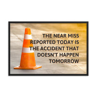 A workplace safety poster showing an orange safety cone with the slogan the near miss reported today is the accident that doesn't happen tomorrow.