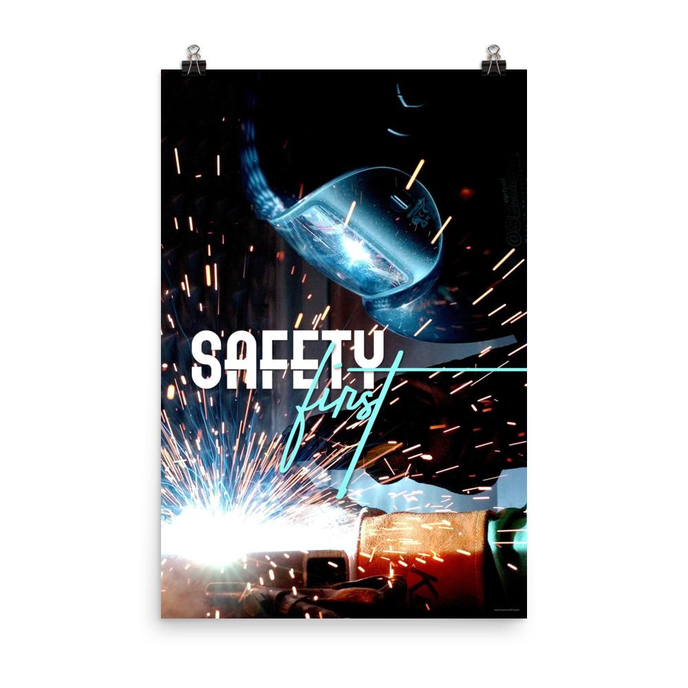A safety poster showing a close-up of a welder welding a pipe while wearing a welding hood with bright sparks flying all around with the slogan safety first.