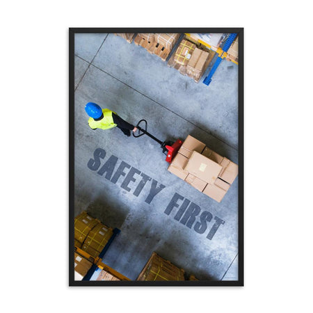 A safety poster showing a bird's-eye view of a worker in a warehouse pulling boxes on a pallet jack with the slogan safety first in bold letters.