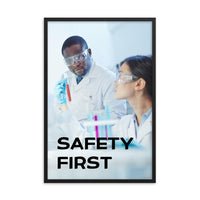A safety poster showing two lab workers collaborating on a project in a lab while wearing full PPE with the slogan safety first.