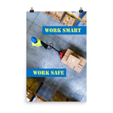 A safety poster showing a bird's-eye view of a worker in a warehouse pulling boxes on a pallet jack with the slogan work smart, work safe.