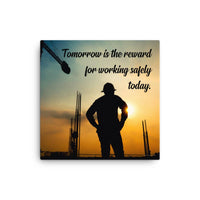 A safety poster showing a worker on a construction site being silhouetted by a sunset of orange and blue colors with the slogan tomorrow is the reward for working safely today.